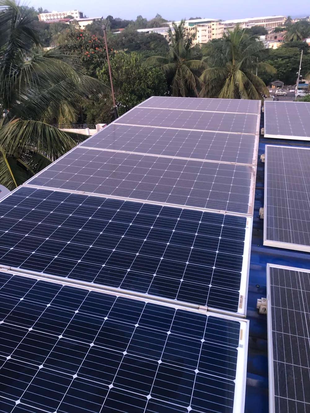 Rows of solar panels installed across a sloped residential rooftop